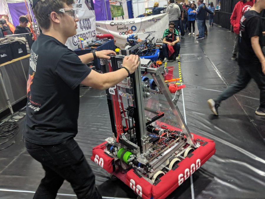 PREPARATION: In the gym at Da Vinci High School in El Segundo, junior Joey Blumofe pushed Shalhevets robot toward the field to cue for the next match.