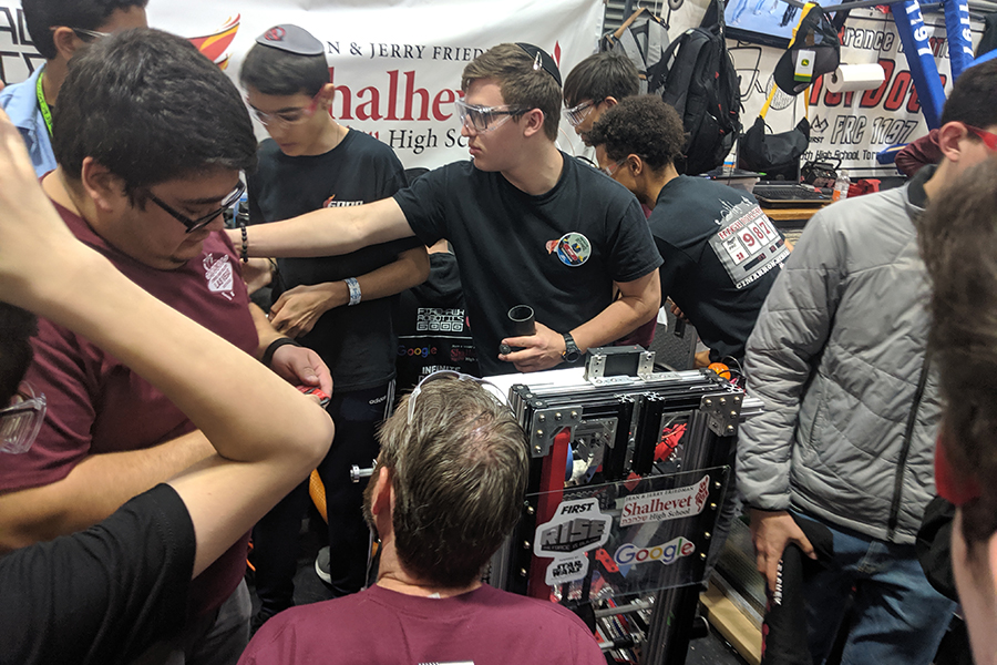 HUSSLE: Right after being picked to be part of an alliance with the top two ranked teams, Firehawks Robotics fixed up their robot for quarter-finals, with the help of teams from Las Vegas and Culver City.