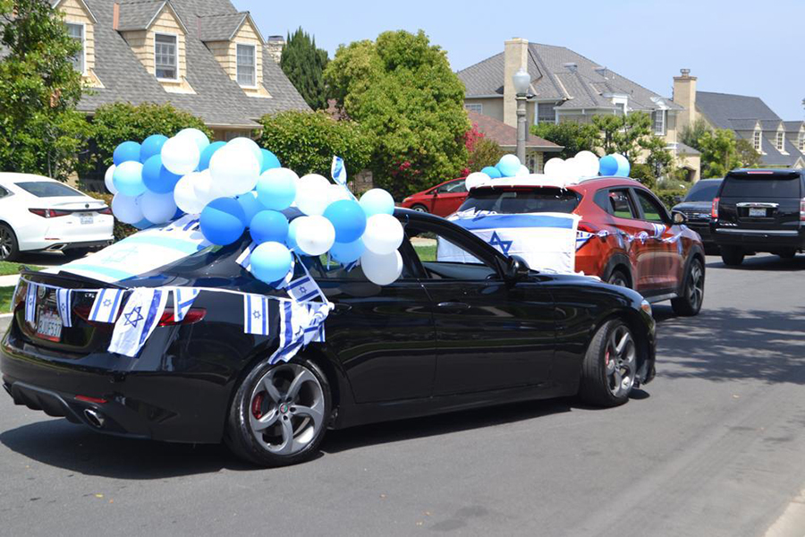 DIFFERENT: Seniors and a few faculty drove down Cresta Drive in the Yom Haatzmaut car parade April 29. A total of 46 vehicles joined the line, which zig-zagged for 4.9 miles.