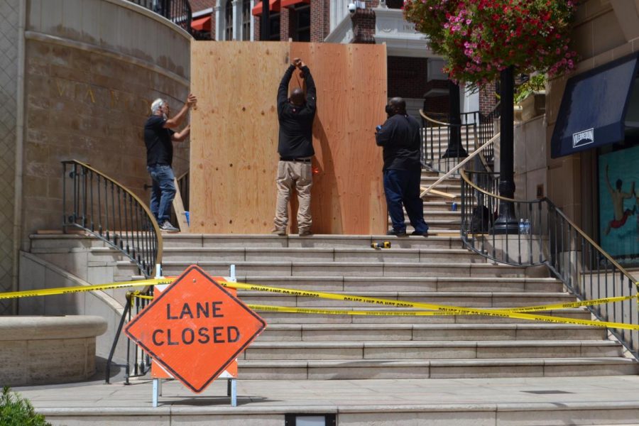 Workers boarded up the entrance to the Rodeo Collection on Wilshire Boulevard at Rodeo Drive Sunday after luxury stores were looted in Beverly Hills Saturday night.