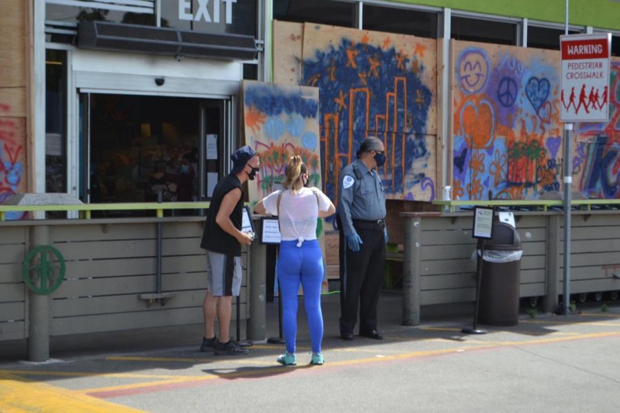 Citizens painted peace signs and messages of support Sunday on the boarded-up windows of a restaurant that had been attacked on Fairfax Avenue.