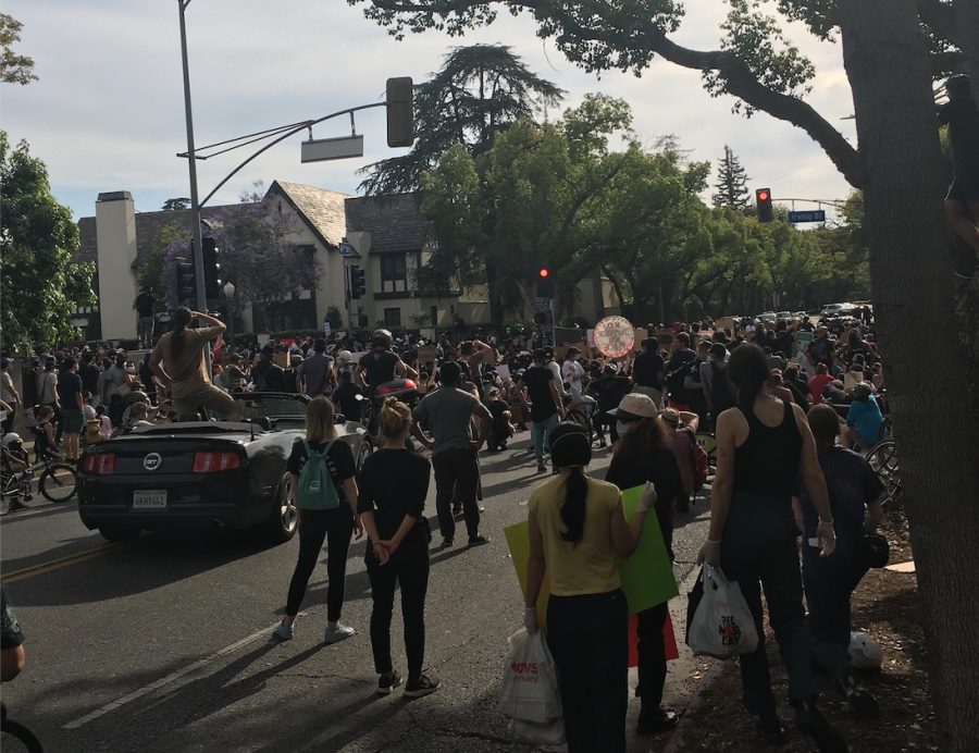 Protesters gathered outside the mayors mansion on Irving Boulevard in Hancock Park Sunday to demand reduced funding for the Los Angeles Police Department.