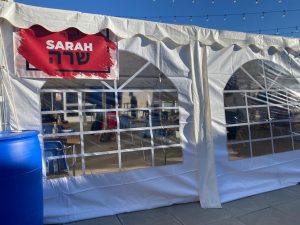 NAMES: New tents set up to accommodate in-person outdoor learning are named after the patriarchs and matriarchs. Tents Sarah and Abraham are on the third-floor patio; tents Leah, Yaakov, and Rachel are on the turf; and tents Yitzchak and Rivka are in the parking lot.