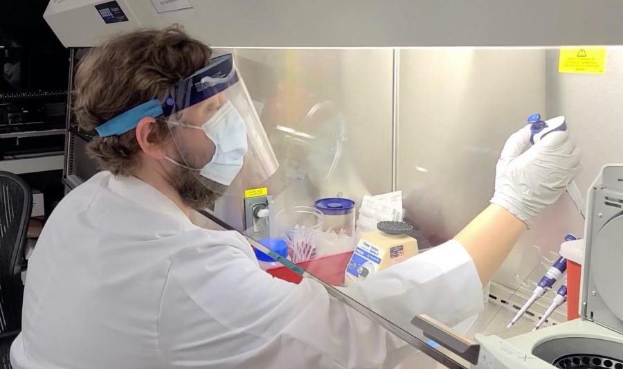 MASKED: Dr. Eric Vail works in the clinical molecular pathology lab at Cedars-Sinai, wearing PPE to protect himself from Covid-19 samples he is studying. 
