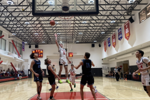 RESUMED: Firehawk shooting guard Jacob Pofsky launched a basket over the heads of defenders from Buena High School in Ventura Thursday night. Due to Covid rules, only 40 spectators, at left, were able to watch in person. Others watched a live but private video feed.