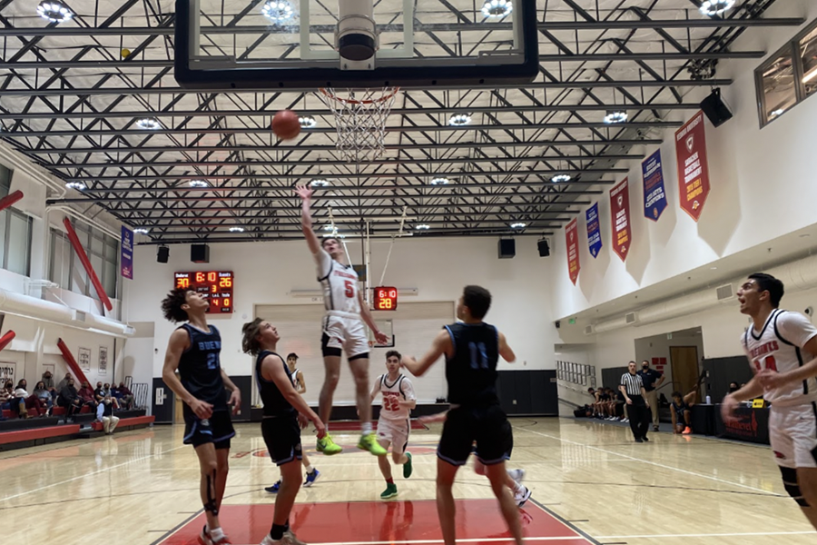 RESUMED%3A+Firehawk+shooting+guard+Jacob+Pofsky+launched+a+basket+over+the+heads+of+defenders+from+Buena+High+School+in+Ventura+Thursday+night.+Due+to+Covid+rules%2C+only+40+spectators%2C+at+left%2C+were+able+to+watch+in+person.+Others+watched+a+live+but+private+video+feed.