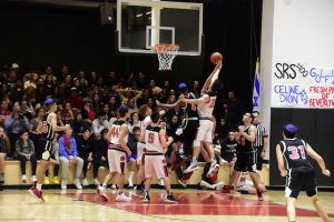 REBOUND: Firehawk forward Jacob Benezra ‘20 went for a rebound in November 2019 as the Frisch Cougars topped the Firehawks 56-51 in the championship game. A large crowd filled the Shalhevet gym, including a new seating area added that year for overflow.