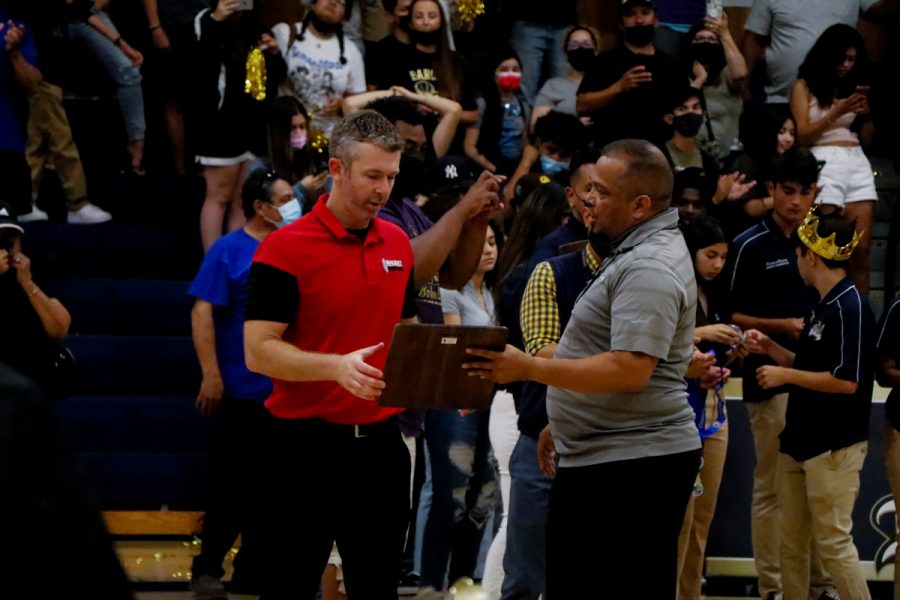 PRESENTATION: The  crowd at Bonita Vista High School in Chula Vista crowd looks on as  Coach Ryan Coleman accepts the runner-up plaque from the home team’s athletic director. 