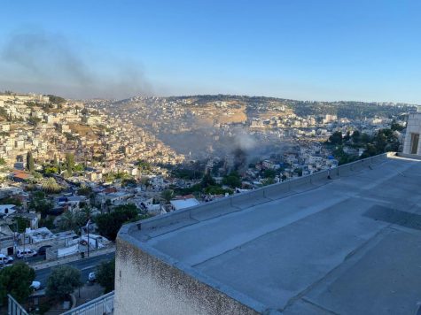 OVERLOOK: From the balcony of his dorm overlooking the Kotel, David Edwards 20 photographs smoke rising where fireworks had ignited grass fields after being launched from Silwan in East Jerusulam before Shabbat on May 14.