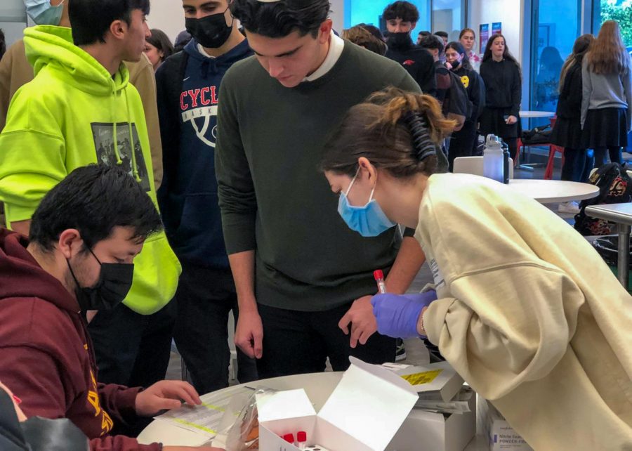 MASKLESS: Students lined up for PCR tests in the cafeteria last Friday, almost none wearing a mask. Two students, both seniors, tested positive, along with a staff member – all of them vaccinated.