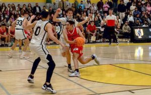 AGGRESSIVE: Junior Nathan Sellam drove to the hoop in front of the YULA crowd as the Shalhevet Firehawks defeated the YULA Panthers 51-43 last Thursday night. Nathan had eight points, the second-most on the team. 