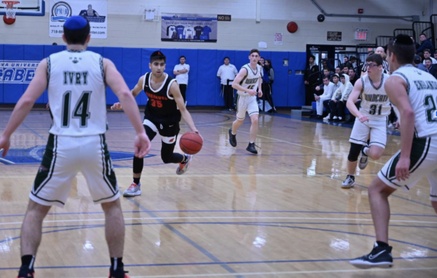 DRIVE: Junior Avi Halpert, who plays point guard for the Firehawks, dribbled to the basket against DRS March 24. The Firehawks lost the game 56-42. 

