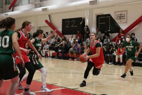 DRIVE: Sophomore Yalee Schwartz ran to the basket and scored a layup during the Firehawks first-round game against the Larchmont Charter Timberwolves on March 1. Yalee had 24 points and the Firehawks won 71-15. 