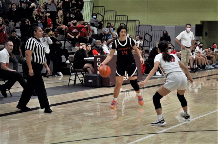 OFFENSE: Junior Talia Tibi, who plays point guard, dribbled around the three-point line as the Firehawks defeated the Verdugo Hills Dons 57-54 on Saturday night. 