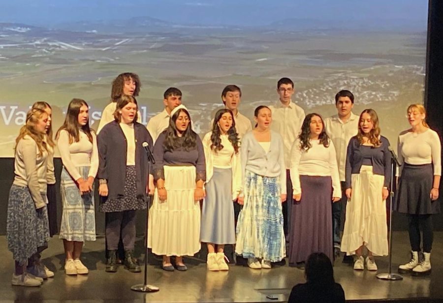 SONG: With a photo of Israel’s Jezreel Valley behind them, the Choirhawks sang Shir Ha’Emek, a pioneer song about that valley, at the Museum of Tolerance.