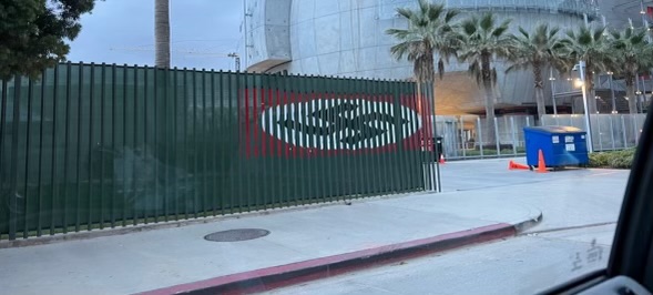 TAPED: A Nazi flag about the size of a billboard appeared briefly on a fenced gate between LACMA and the Academy Museum of Motion Pictures this morning. About 16 feet wide, it may have been made of colored tape or other adhesive.
