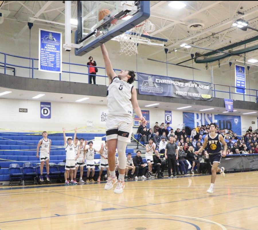 OPEN: Senior Nathan Sellam shoots a layup in Shalhevet’s victory Friday against Magen David. Sellam received multiple full-court passes throughout the game, being wide open and able to score easily.