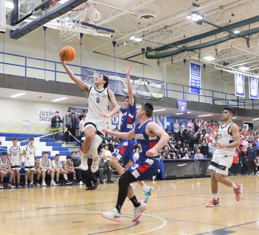 DRIVE: Senior Nathan Sellam jumps to shoot a layup in this afternoon's game against MTA. Shalhevet is the number one seed while MTA is number 16.