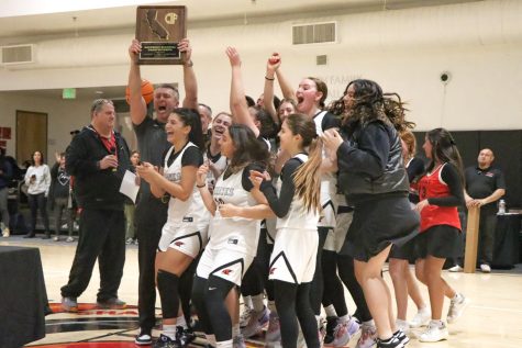 ELATED: Members of the team celebrate with Head Coach Ryan Coleman after winning the Southern California Regional Championship for the second year in a row. They defeated Campbell Hall Tuesday night in the Shalhevet gym.