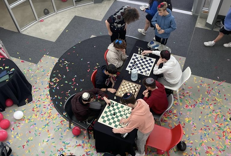 OPENING%3A+Three+simultaneous+chess+matches+were+held+March+13+during+lunch+as+part+of+the+first+round+of+this+years+Chess+Club+tournament.+Confetti+was+left+over+from+a+celebration+of+the+Girls+Basketball+team+CIF+win.