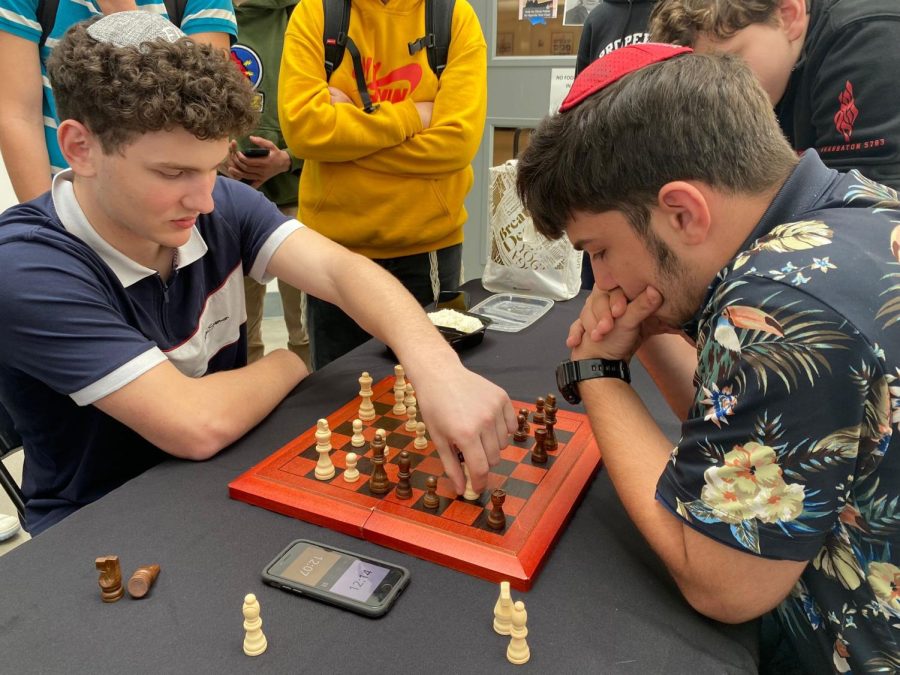 BOLD: Freshman Sam Jacobson, left, makes a move against senior Alon Keiter in the chess club’s championship match April 24.