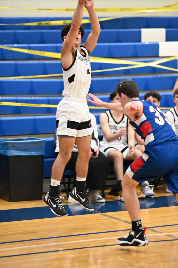 Three-pointer: Sophomore and guard, Aiden Bitran (4), takes a three pointer from the right side corner when playing MTA at Yeshiva University in the Tier 1 qualifier round during the Red Sarachek tournament, March 23. 