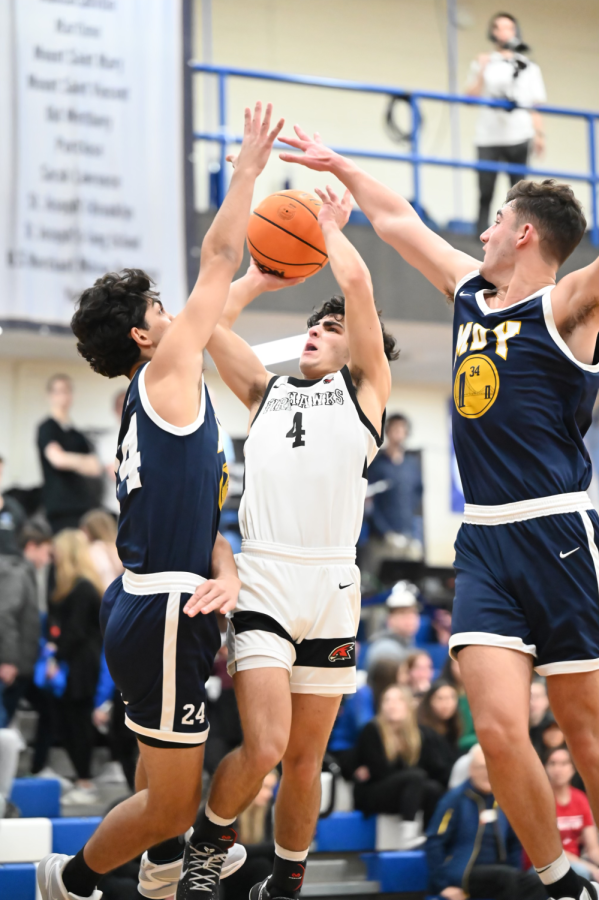 FLOATER: Guard, Aiden Bitran (4), shoots a contested floater while being double teamed when playing Magen David, and then beating in the Tier 1 quarterfinals, during the Red Sarachek tournament, March 24. 