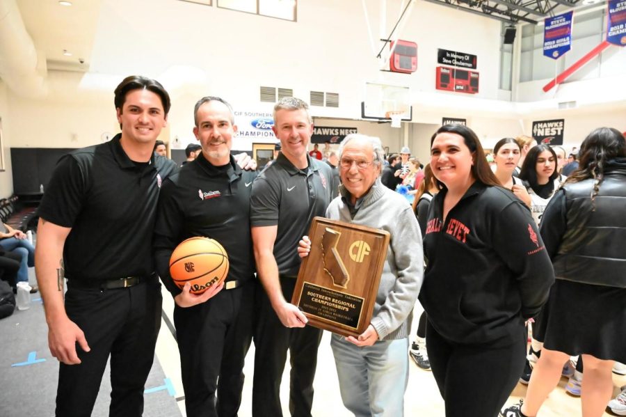 WIN: From left, Coaches Adam Plax, Andrew Schultz, Ryan Coleman and Jena Laolagi with Shalhevet founder Dr. Jerry Friedman, center, holding the championship trophy plaque, celebrated in the gym after the Firehawks won the CIF Southern regional championship against Campbell Hall March 7. 