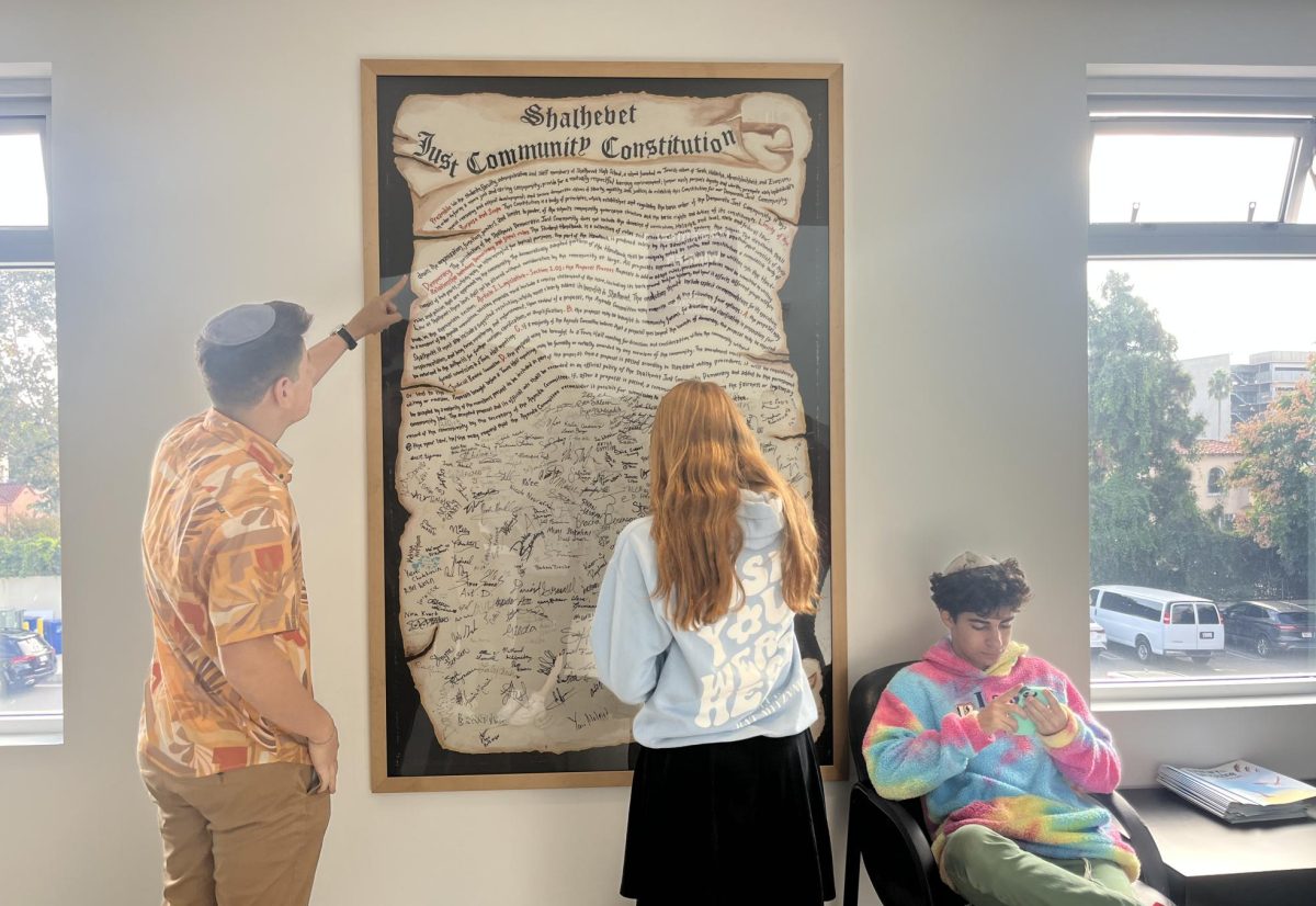 TODAY: Four separate Town Halls, one for each grade, will hear candidate speeches this morning ahead of voting. Above, Agenda Chair Rami Melmed and senior Keira Deutsch studied the Just Community Constitution in the second floor lobby.