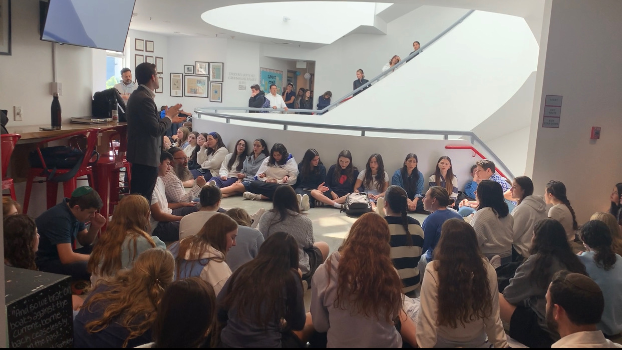 SONG: During Tuesday’s kumzitz, Rabbi Block (standing) told students to find strength in mindfully fulfilling their normal commitments.