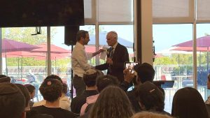 HONORED: Mr. Richard Sandler, Milken Family Foundation’s Executive Vice President, shakes hand with Rabbi Schwarzberg while presenting him the Jewish Educator Award. Neither students nor Rabbi Schwarzberg knew what the surprise assembly was about when the school gathered at the end of the day on Sept. 23.