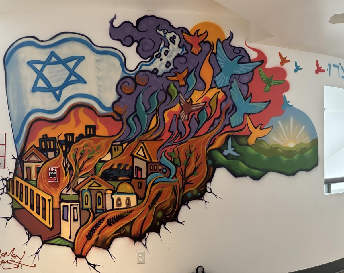 HOMAGE: Mr. Souza, best known for spray-painting murals of Israeli leaders on storefront shutters in Jerusalem’s Machane Yehudah marketplace, created a new second-floor artwork commemerating Oct. 7. The theme is “After things are destroyed, we rebuild,” he said. 