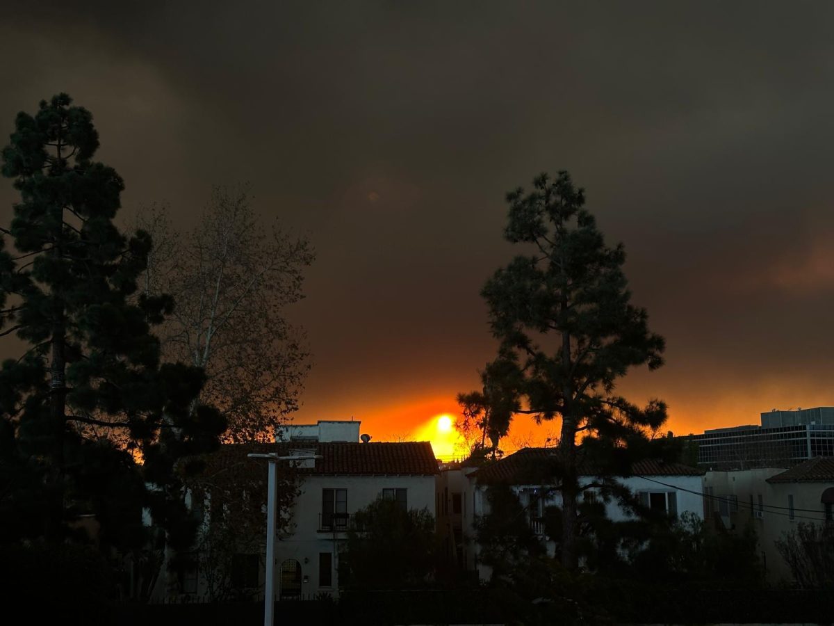 GLOW: The sun burns orange and yellow surrounded by smoke in a rooftop view from Shalhevet the morning of Jan. 8. The sky remained dark throughout 7:20 hashkama minyan and first period.