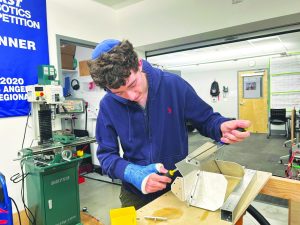 BUILDING: Robotics Captain Benjy Kolieb working on the robot for this year's competition.